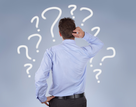 Is Managed Print Services Right for My Business? Image description: Man in blue shirt against blue background. He is scratching the back of his head/neck and is depicted surrounded by numerous white question marks.